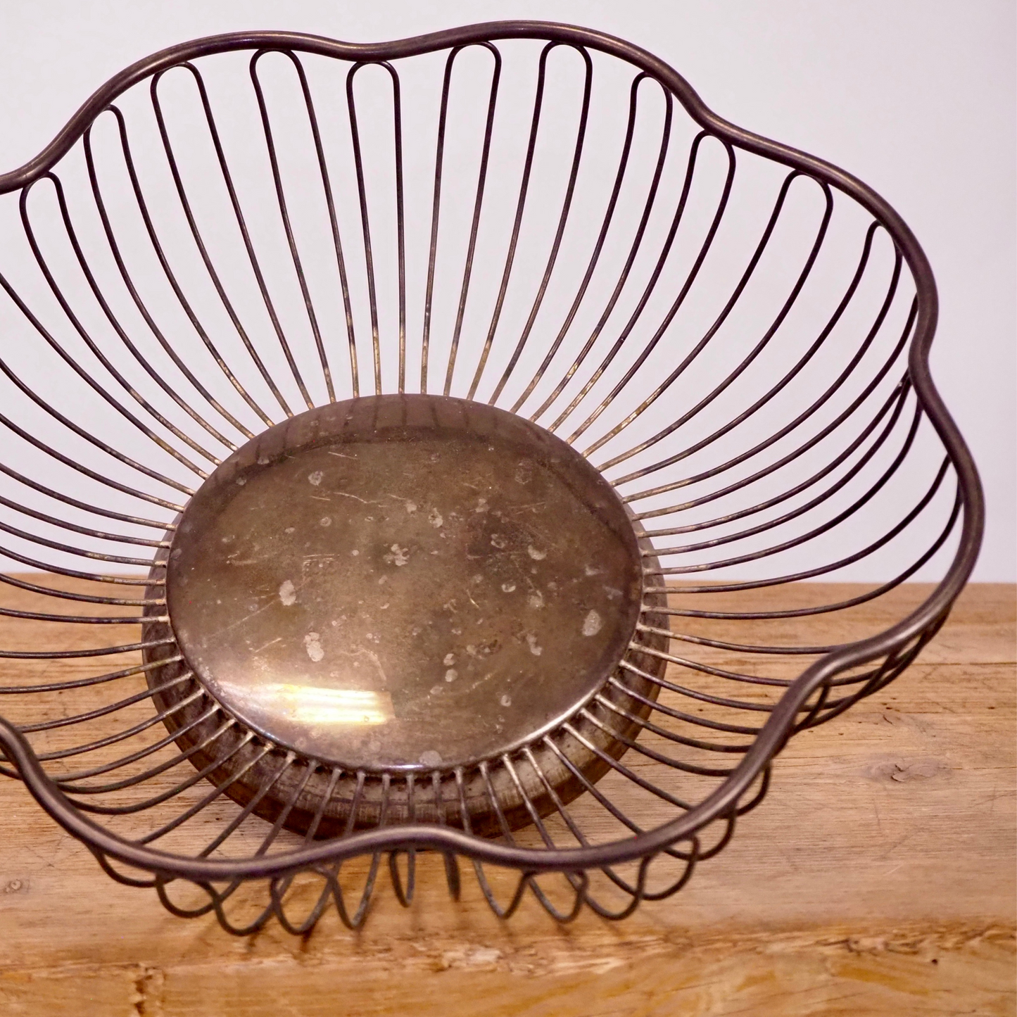 Silver patina scalloped fruit basket with base.