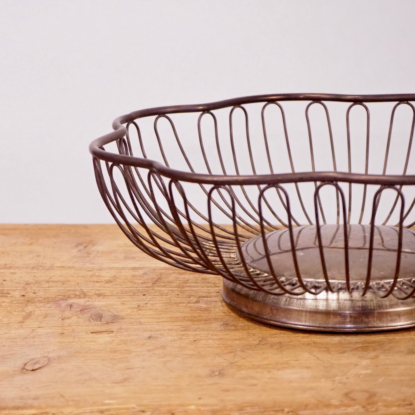Silver patina scalloped fruit basket with base.