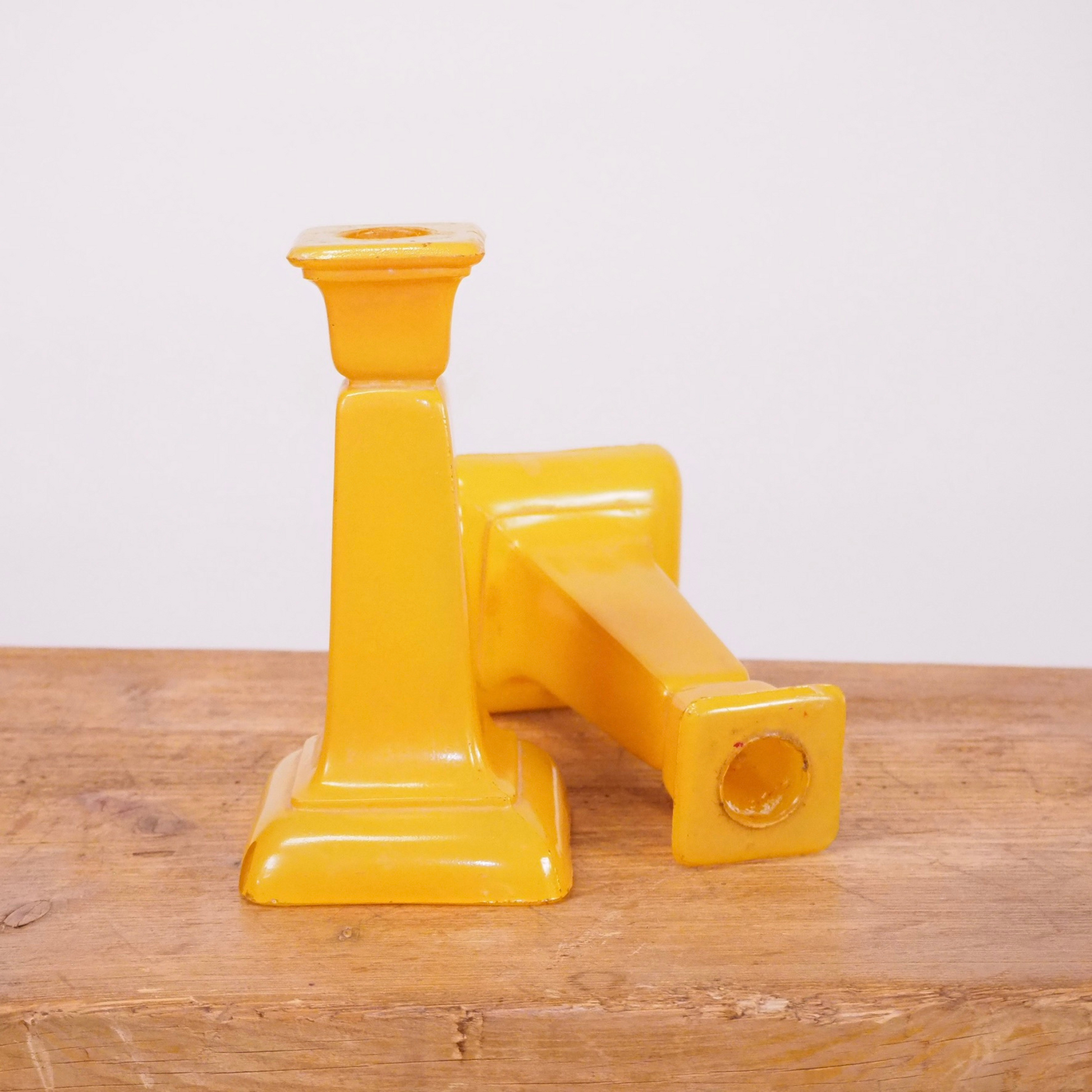 Pair of yellow frosted glass candlesticks with square base.