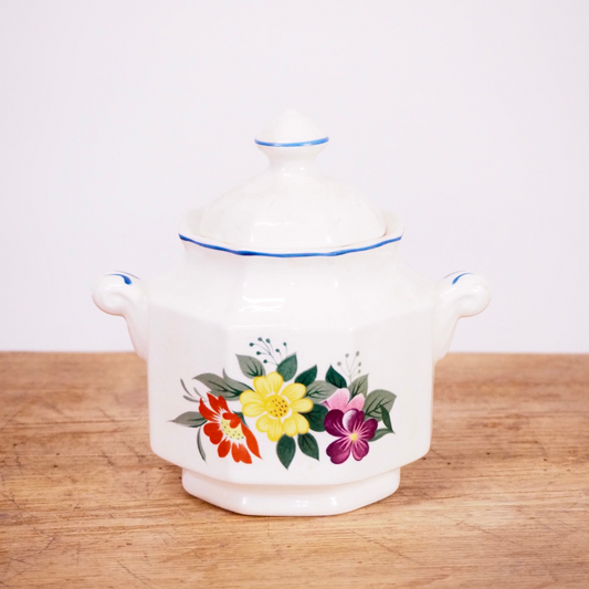 White and floral sugar dish with lid.