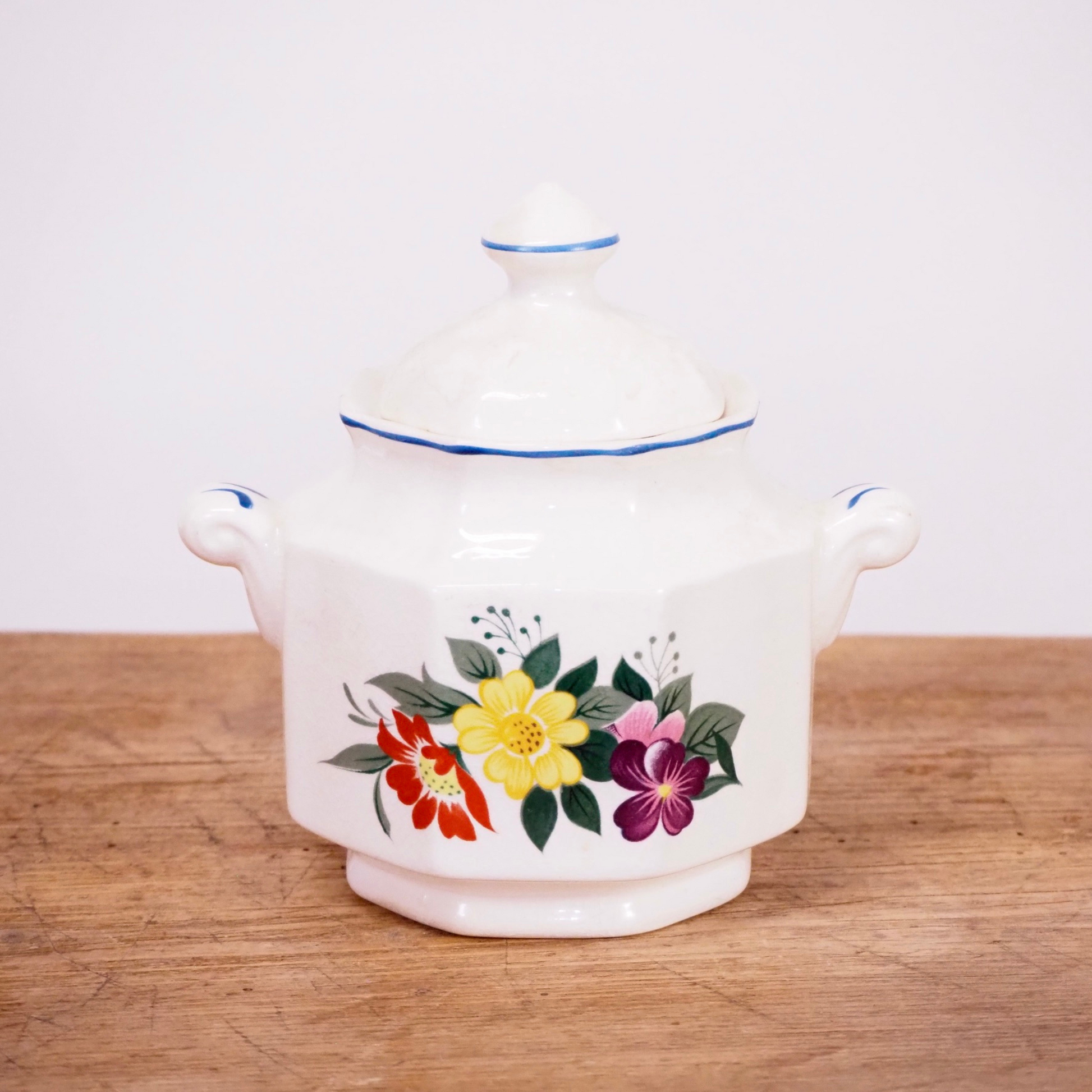 White and floral sugar dish with lid.