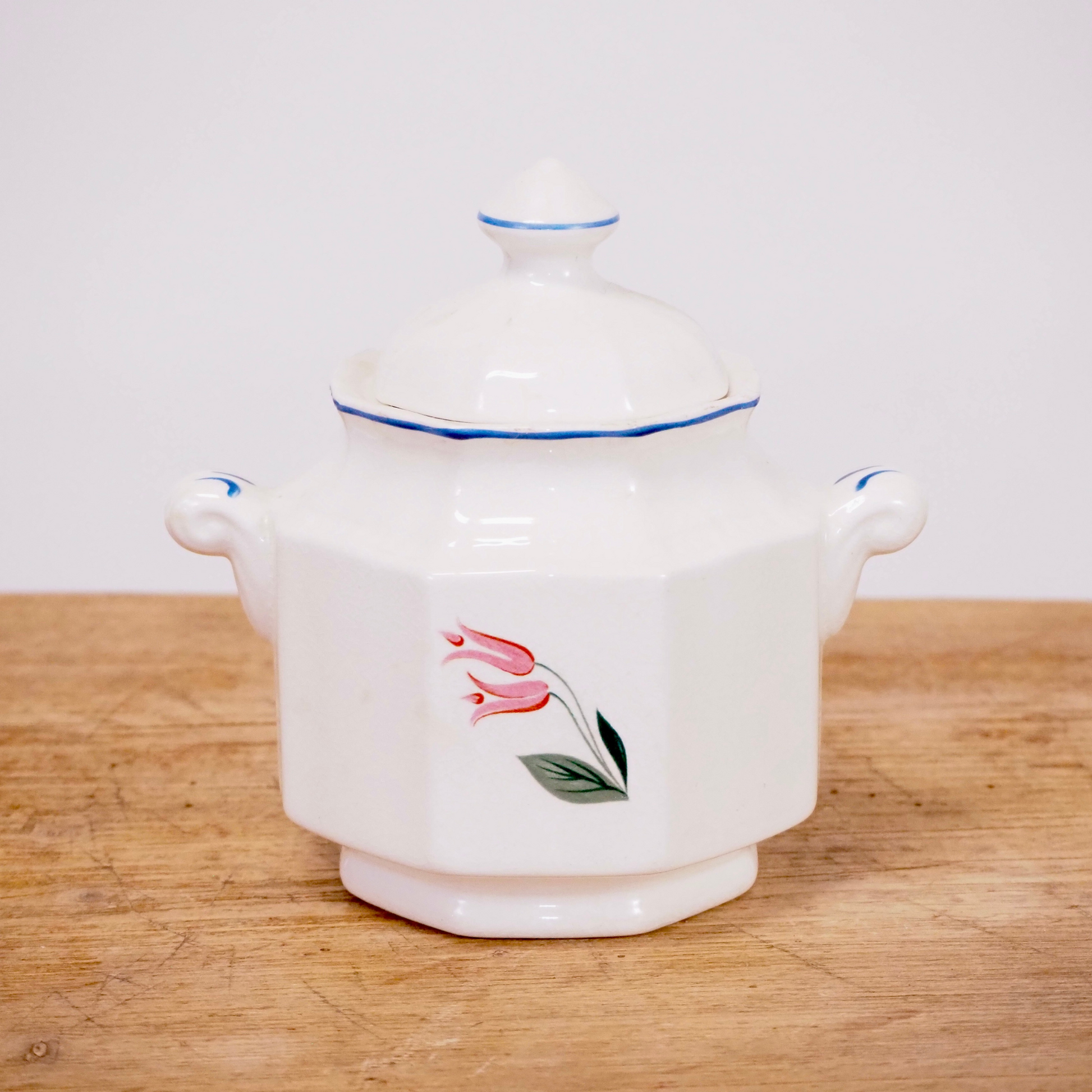 White and floral sugar dish with lid.