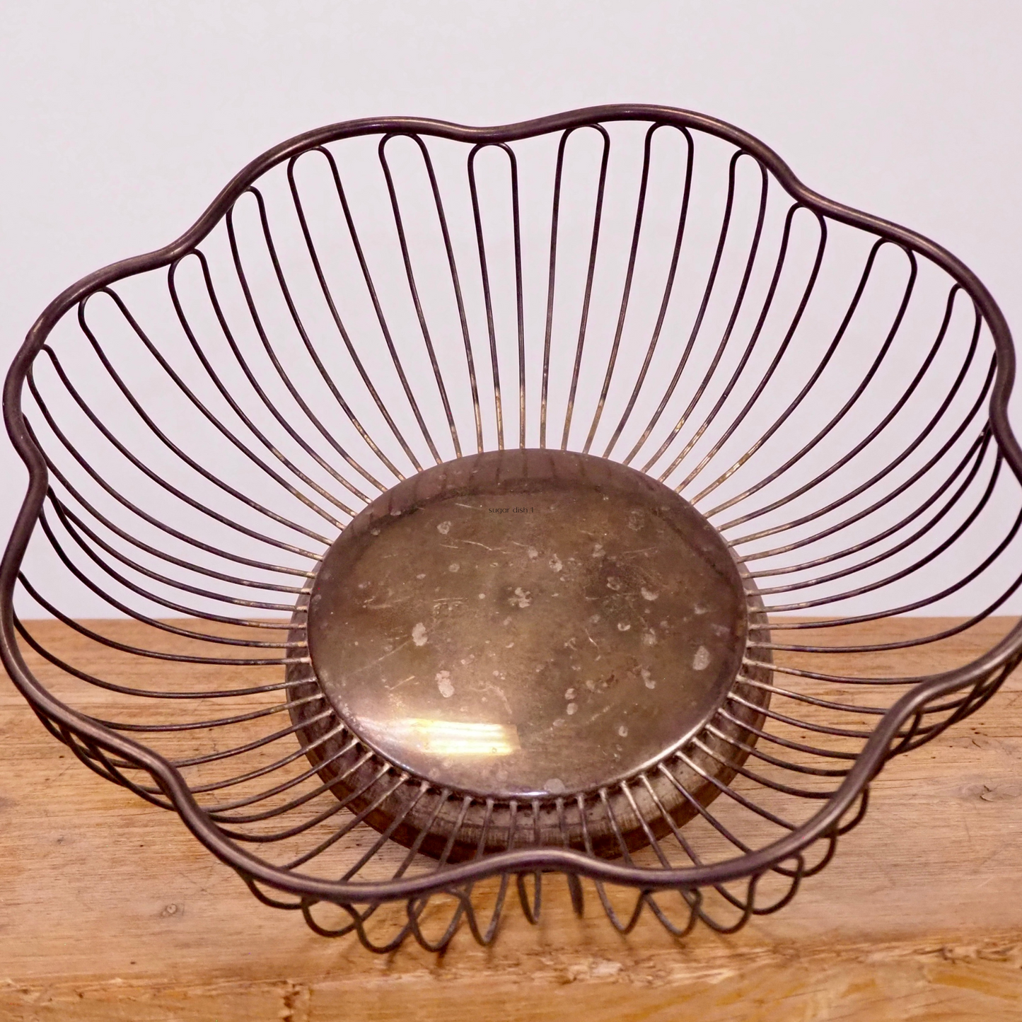 Silver patina scalloped fruit basket with base. 