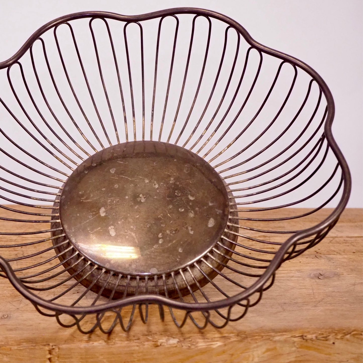 Silver patina scalloped fruit basket with base. 