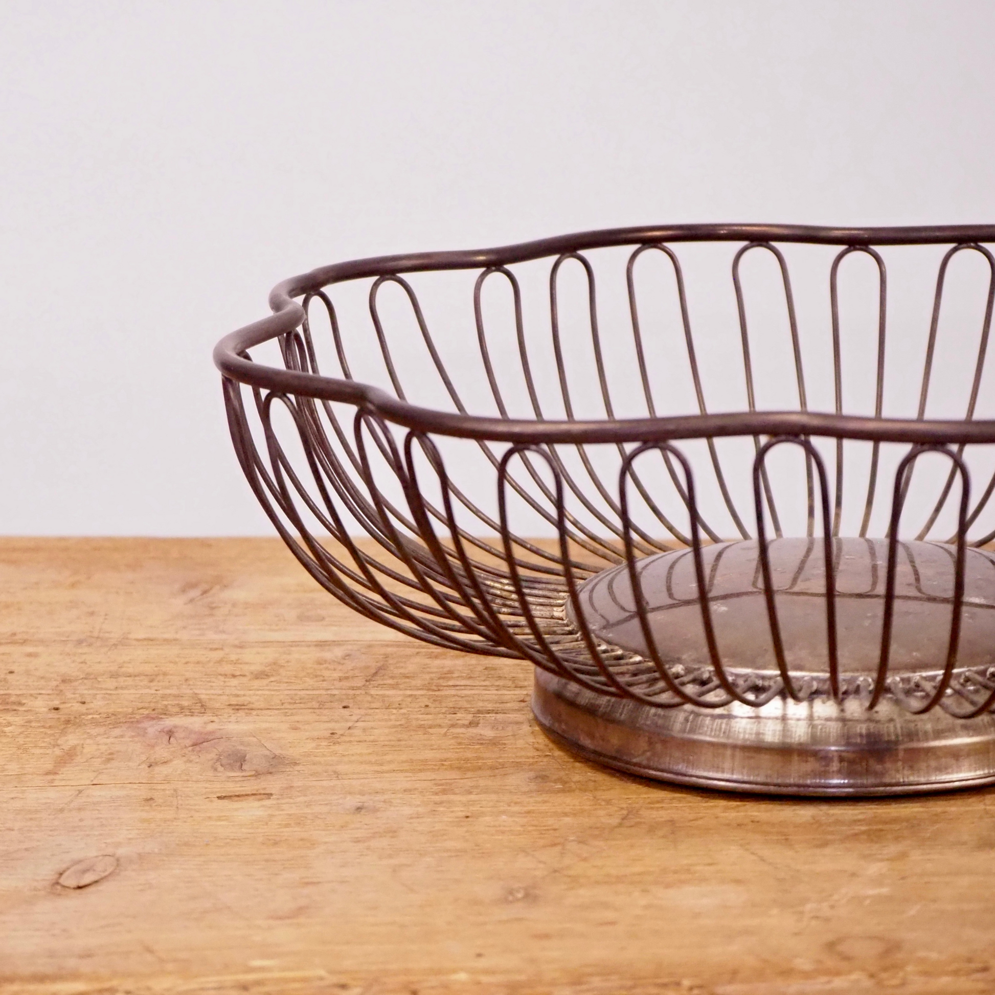 Silver patina scalloped fruit basket with base. 