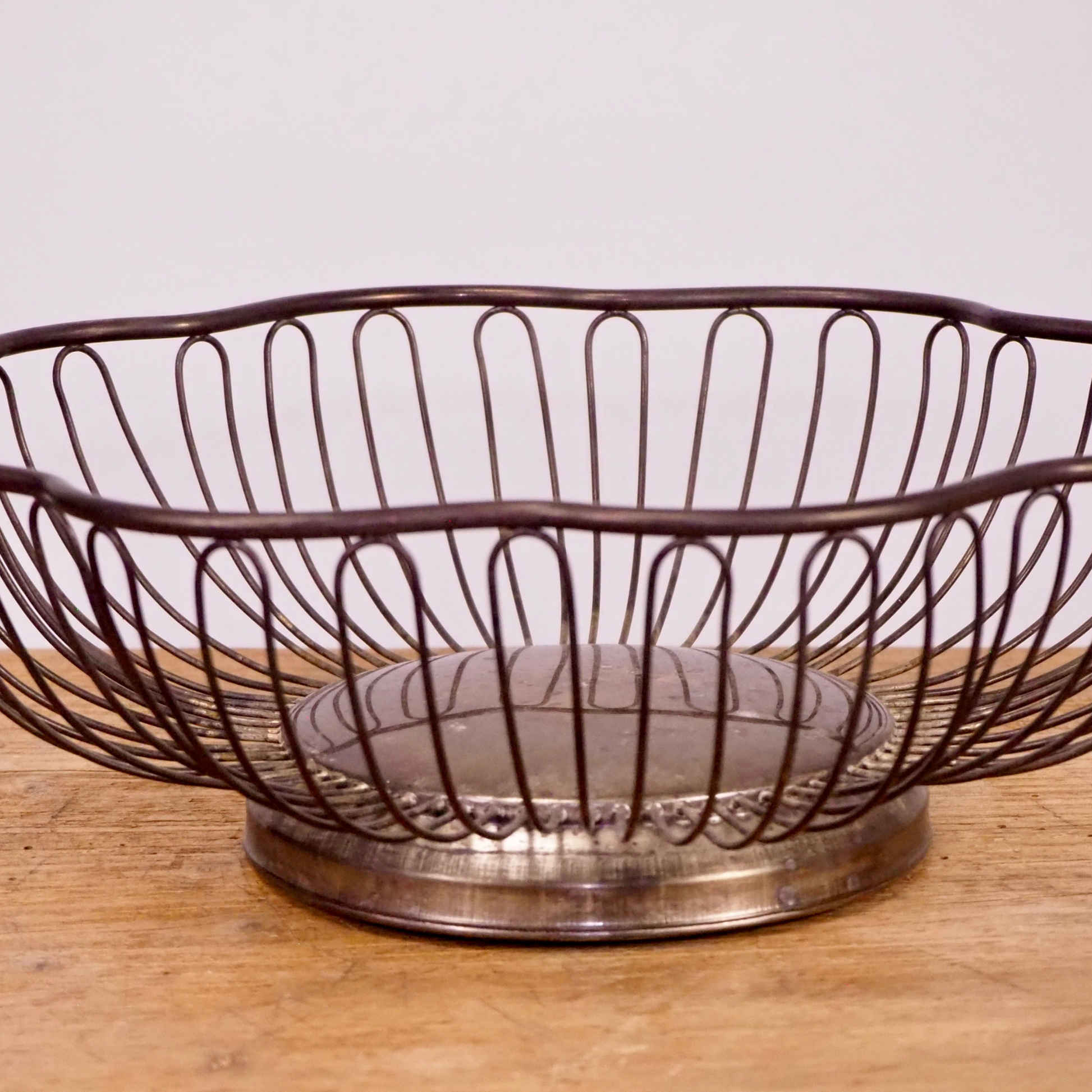 Silver patina scalloped fruit basket with base. 