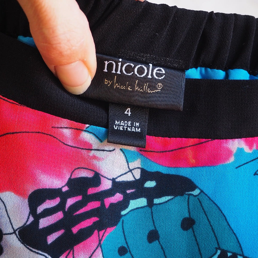 Abstract butterfly print, mermaid cut skirt by Nicole Miller. Label detail.